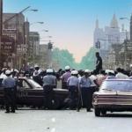 Only hours after the raid, Detroit police stand down temporarily at the behest of Congressman John Conyers who stands on top of a car pleading for calm. It was to no avail.