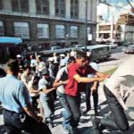 Arrestees run the gauntlet of officers and into 1300 Beaubien to be processed. 